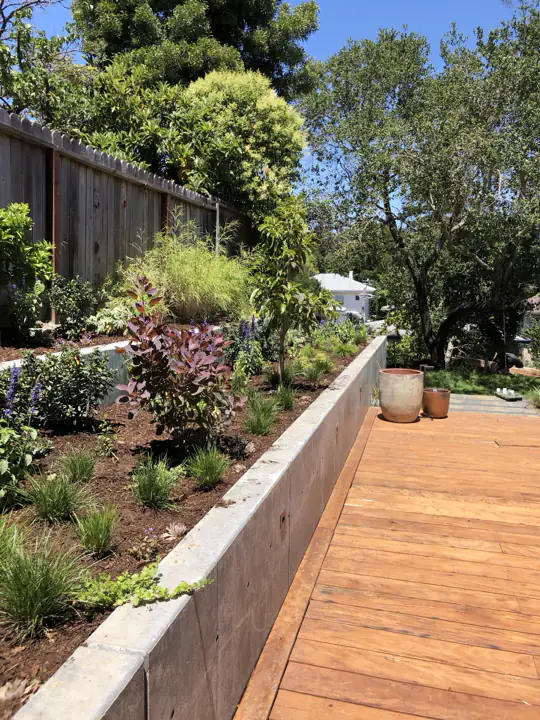 Poured concrete planter wall beside a new deck