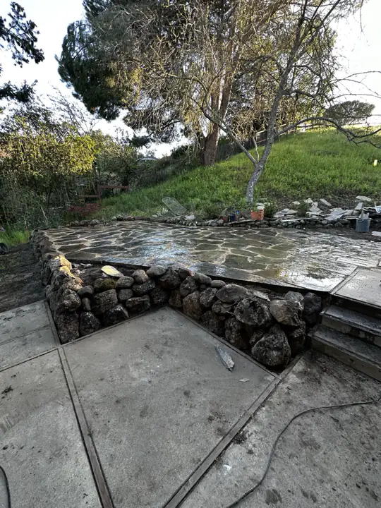 Flagstone terrace on a rough stone wall